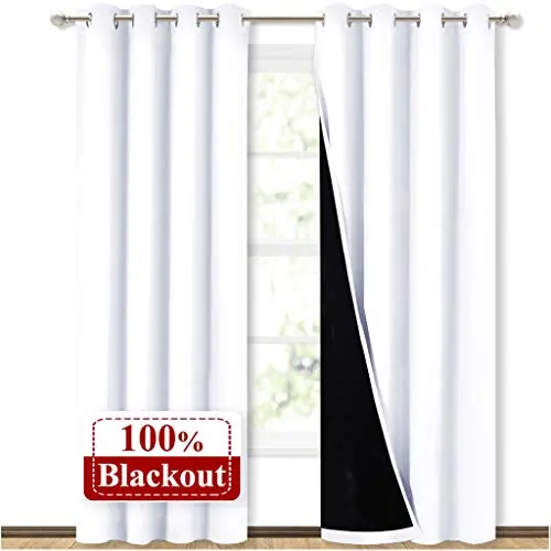 NICETOWN white blackout curtains with grommet top hanging on window